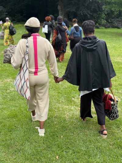 women walking hand-in-hand